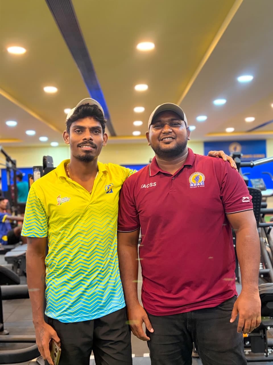 R. Arunraj alongside an elite athlete at a high-performance training centre